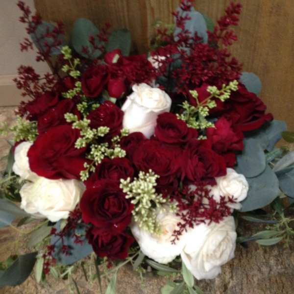 Bouquet of red and white roses with blue-gray foliage
