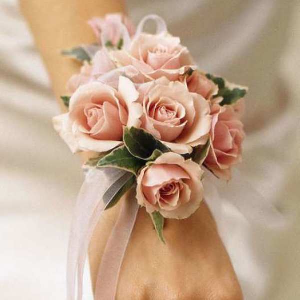 Pink rose wrist corsage with a sheer ribbon
