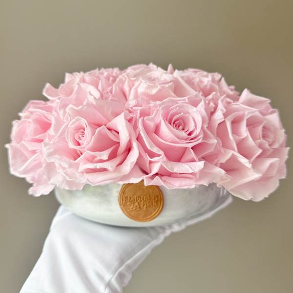 Pink rose bouquet in a round hat box with a ribbon