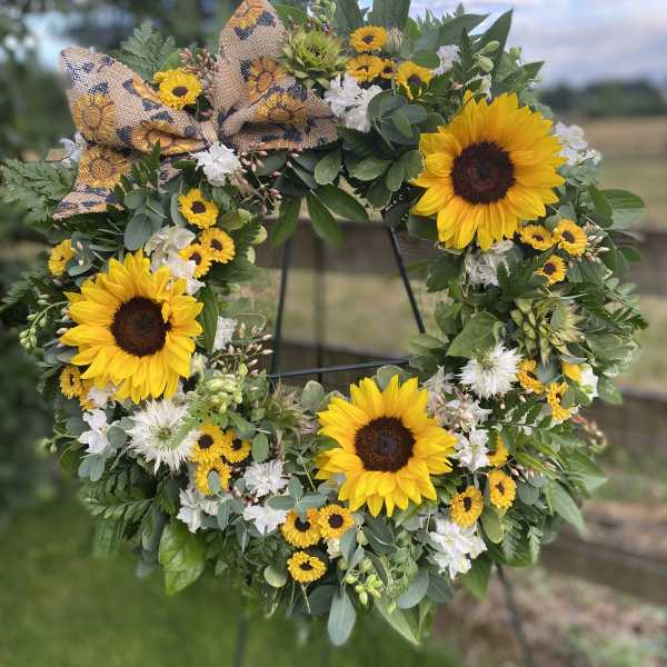 Sunflower wreath with white flowers and a burlap bow