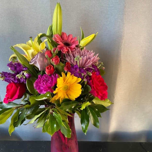 Colorful mixed bouquet in a pink glass vase