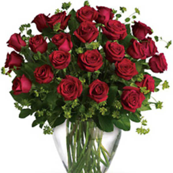 Red roses arranged in a clear glass vase