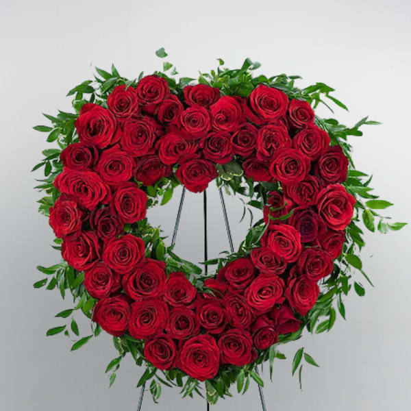 Heart-shaped wreath of red roses on a standing easel