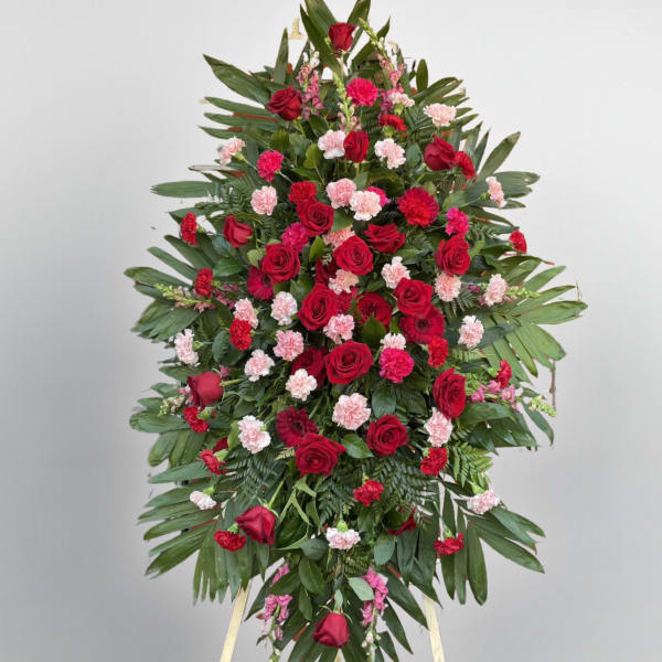Large standing floral spray with red roses and pink carnations