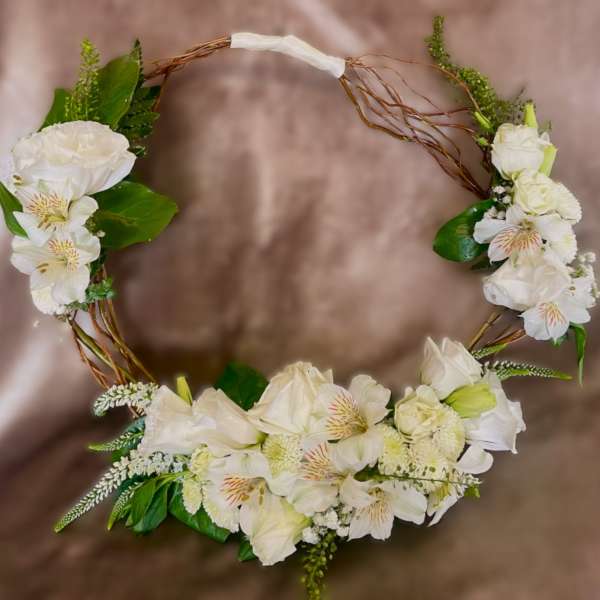 White floral wreath with roses and alstroemeria on a twig frame