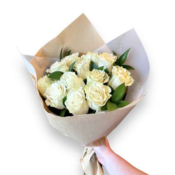 Bouquet of cream roses wrapped in beige paper