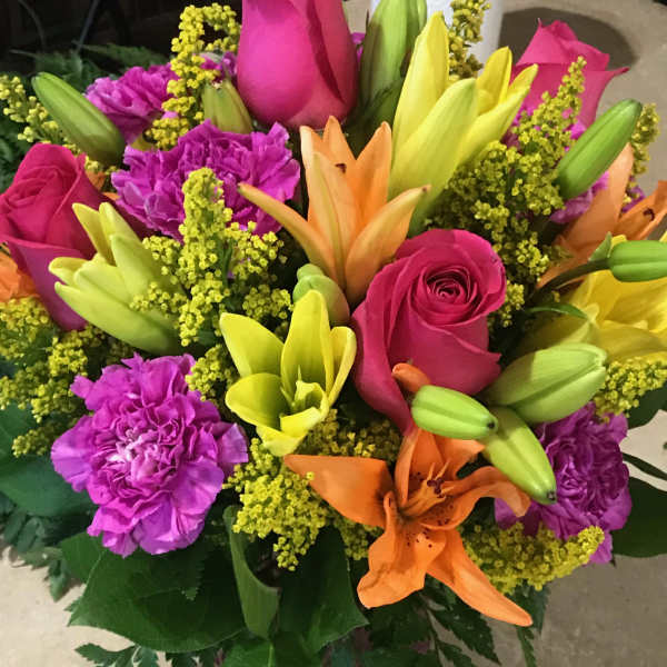 Bouquet of pink roses, lilies, and purple carnations