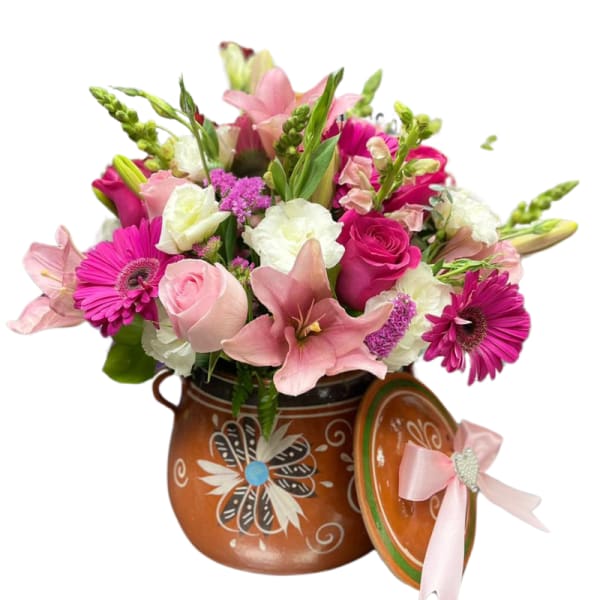 Pink and white mixed flower arrangement in a painted ceramic pot with matching lid and ribbon.
