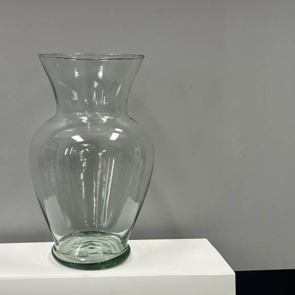 Clear glass vase on a white pedestal