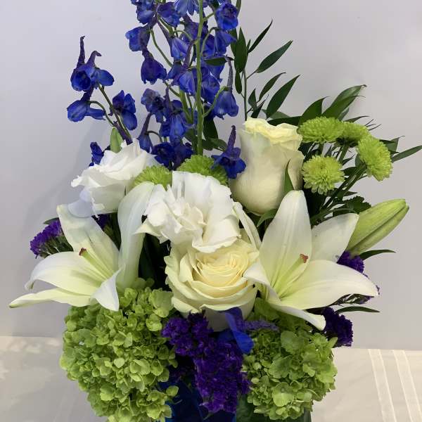 Blue and white floral arrangement in a cobalt vase
