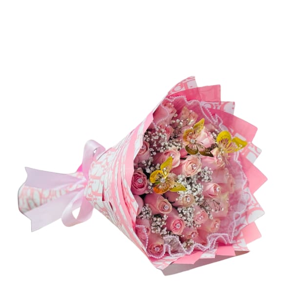Wrapped bouquet of pink roses with white filler flowers in pink patterned paper