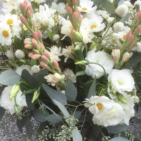 White daisies and lisianthus with pink buds in a loose bouquet