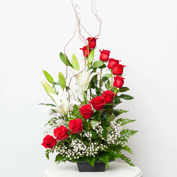 Red roses and white lilies in a black container