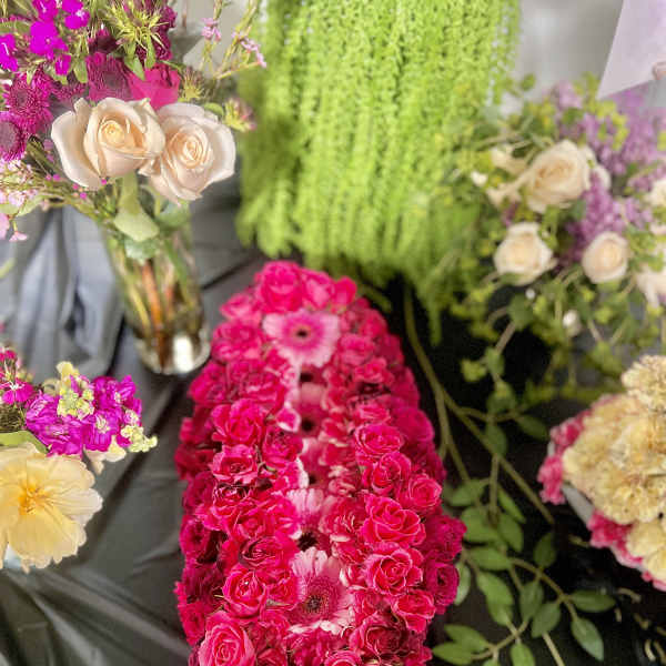Bright pink rose and gerbera floral arrangement with cream roses