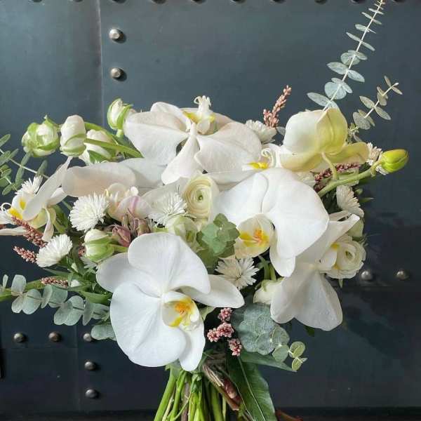 White orchid bouquet with eucalyptus and small white blooms