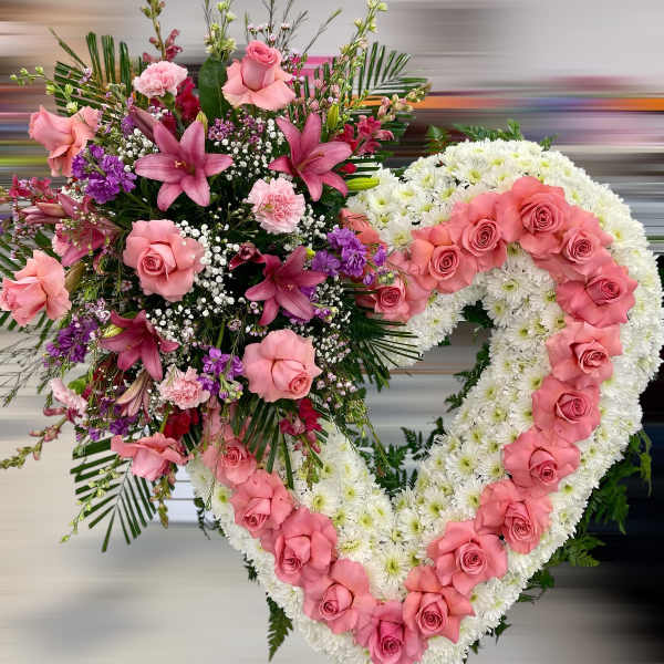 Standing heart-shaped sympathy wreath of white mums with pink roses and lilies.