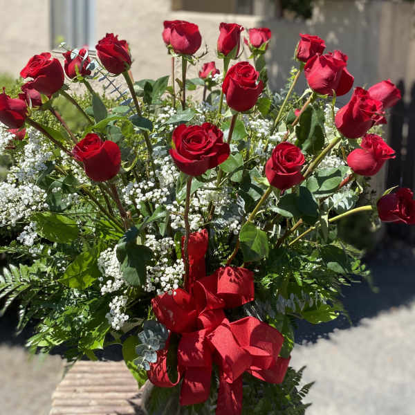 Bouquet of red roses with baby's breath and a red ribbon