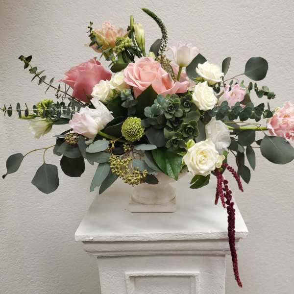 Mixed pink and white flower arrangement in a white vase