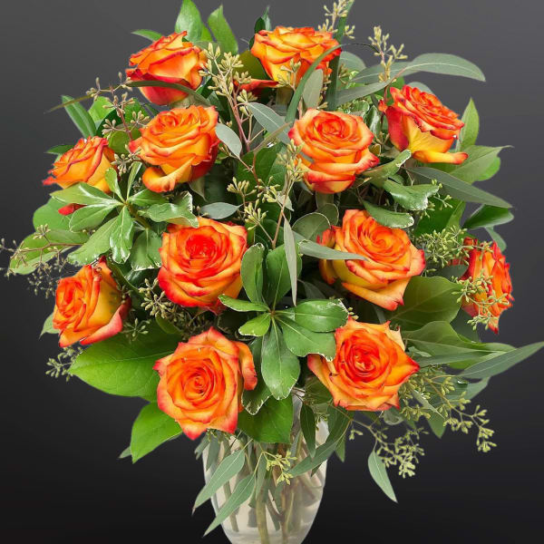 Bouquet of orange roses in a clear glass vase