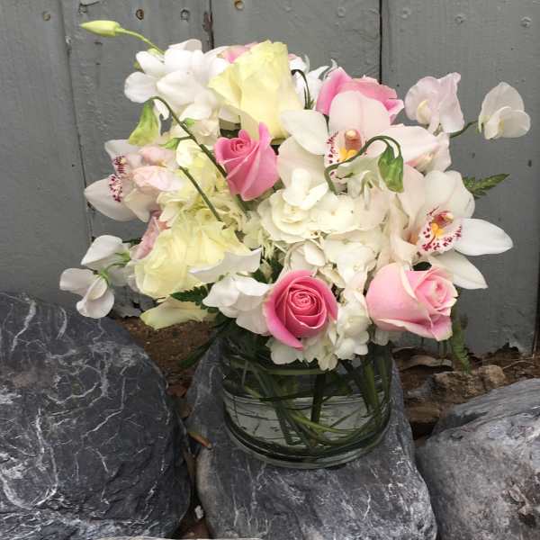 Pink and white bouquet in a clear glass vase