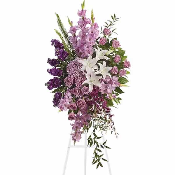 Tall standing floral spray with purple and white flowers on an easel