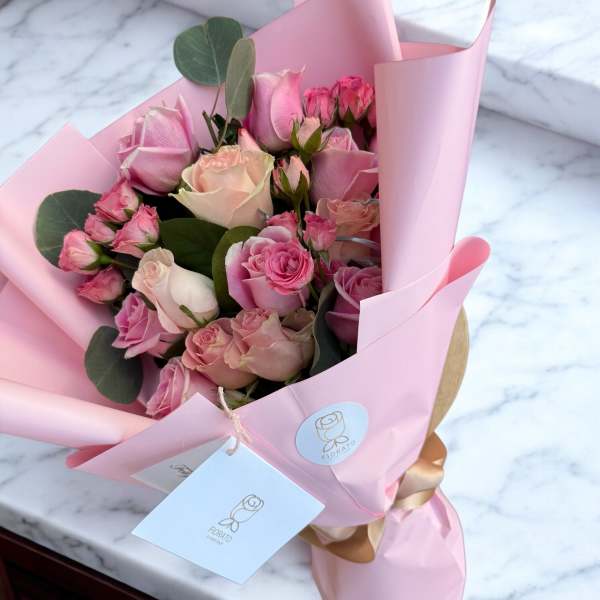 Pink rose bouquet wrapped in pastel paper