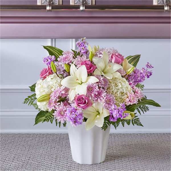 Pink and white floral arrangement in a white vase