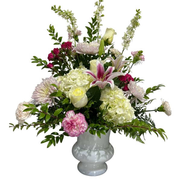 Pink and white mixed flower arrangement in a white vase