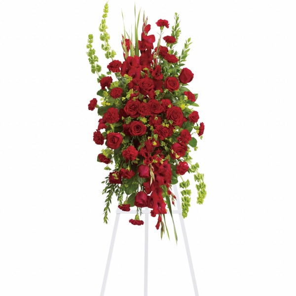 Tall red floral standing spray on a white easel