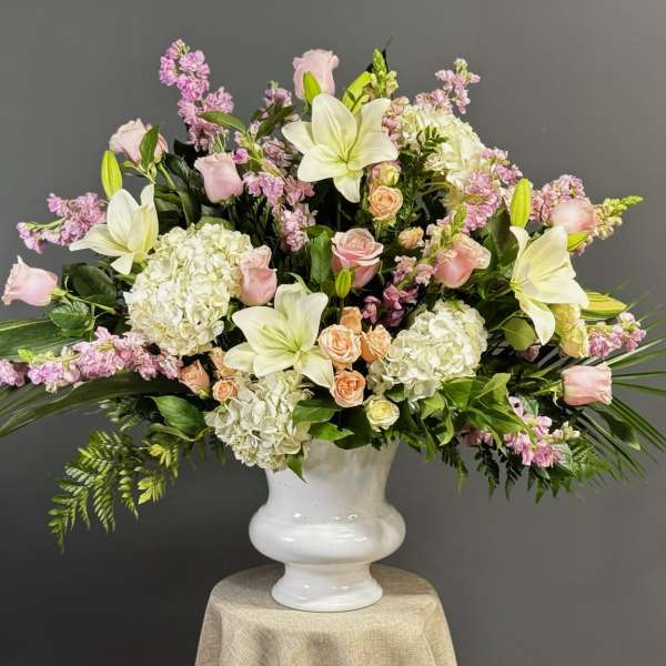 Pink and white floral arrangement in a white vase