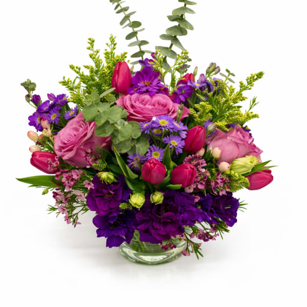 Pink and purple mixed bouquet in a clear glass vase