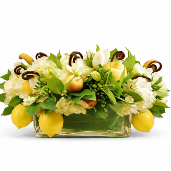 White floral arrangement with lemons in a glass vase