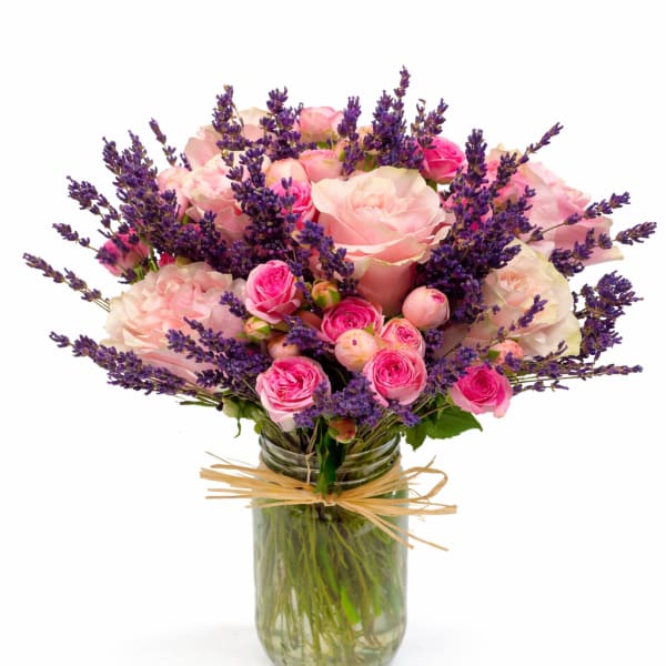 Pink roses and purple lavender in a glass jar vase