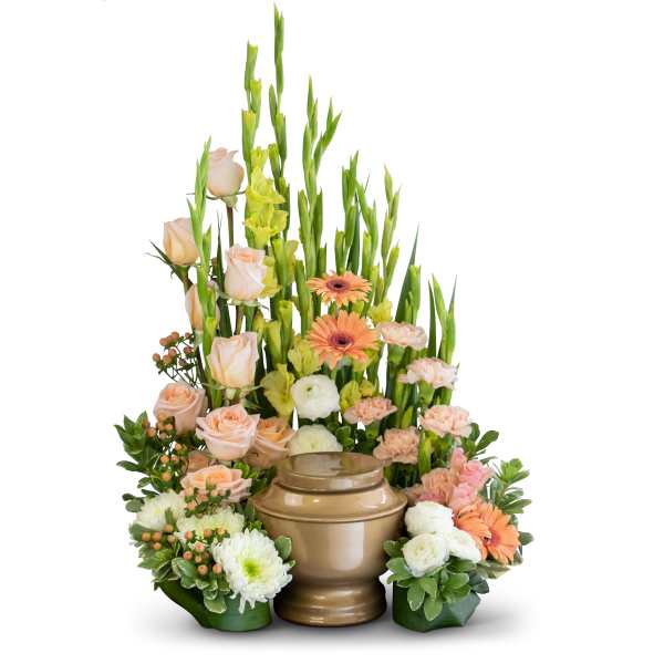 Peach roses and orange gerberas arranged around a bronze urn