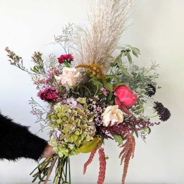 Loose bouquet with roses, hydrangea, and dried grasses