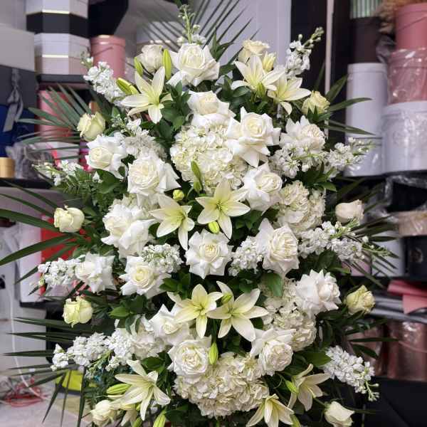 Large white floral spray with roses and lilies