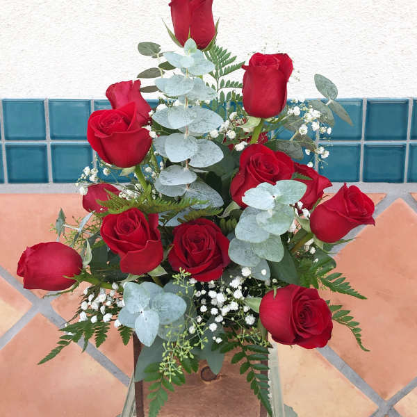Bouquet of red roses with pale blue eucalyptus and baby's breath