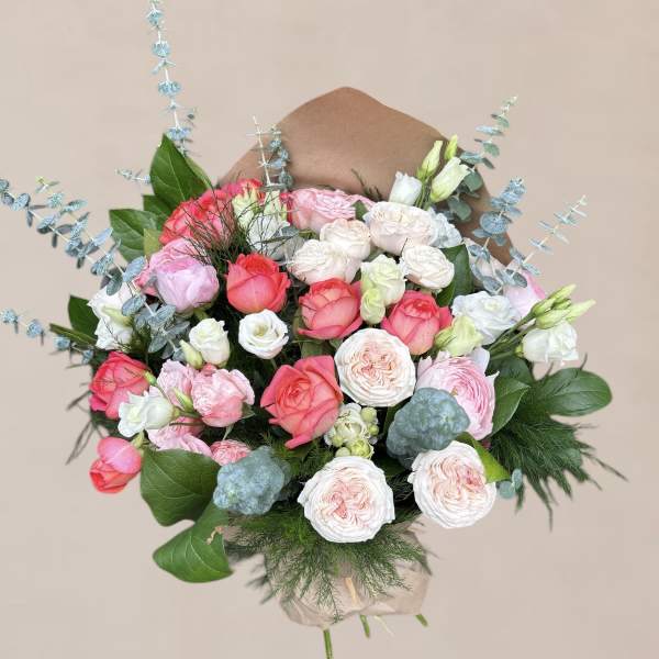 Bouquet of pink and white roses with blue eucalyptus accents