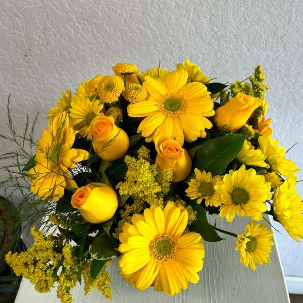Yellow bouquet with gerbera daisies, roses, and small pom flowers