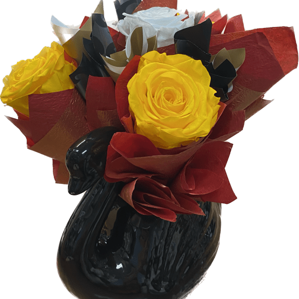 Yellow roses in a black vase with red and black wrapping