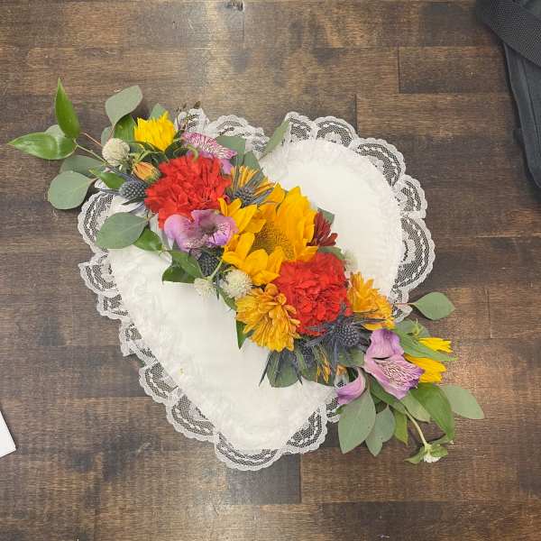 Heart-shaped lace pillow with a colorful floral garland