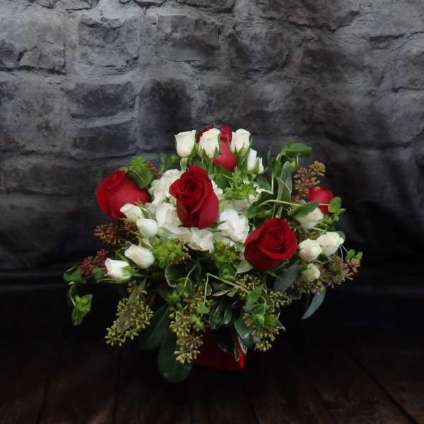 Bouquet of red and white roses with greenery