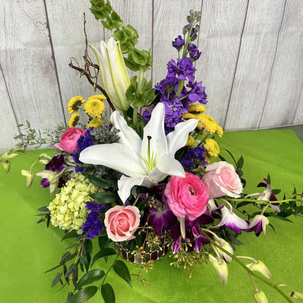 Mixed bouquet with white lilies, pink roses, and purple flowers