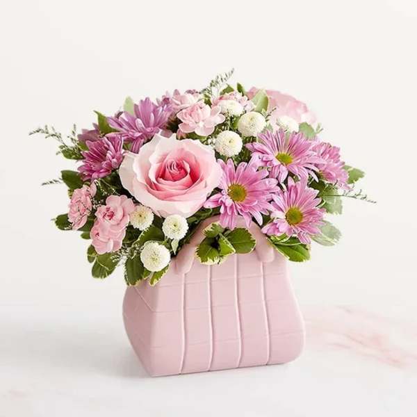 Pink rose and daisy bouquet in a blush pink vase