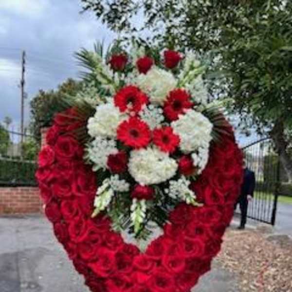 Heart-shaped standing floral tribute with red and white flowers