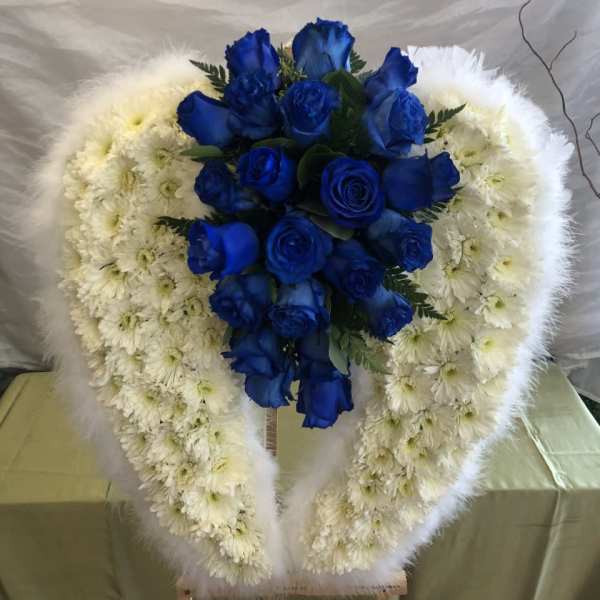 Blue roses in a white floral heart wreath