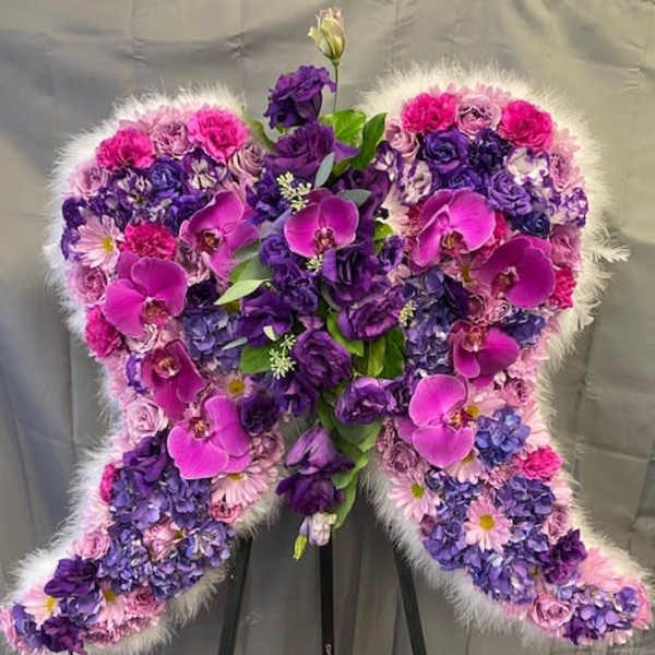 Heart-shaped floral standing spray in pink and purple tones