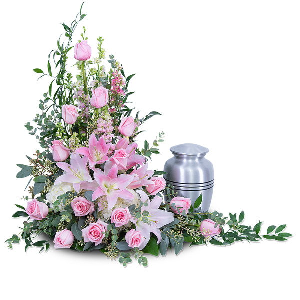 Pink lilies and roses arranged beside a silver cremation urn.