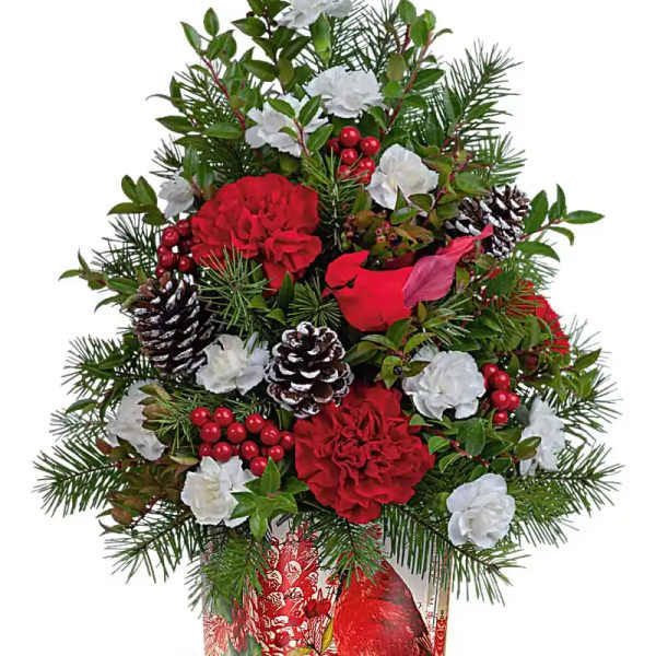 Christmas arrangement with red and white flowers in a decorative tin