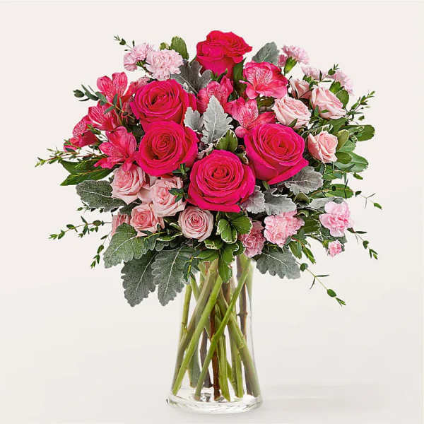 Pink rose and carnation bouquet in a clear glass vase
